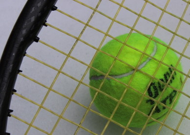 Tennis ball and racket in snow